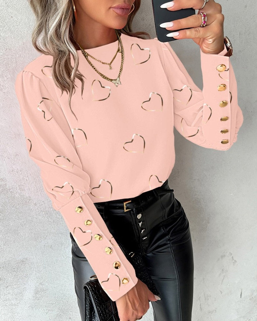 Damesblouse met hartjesprint en pofmouwen, details met gouden glans